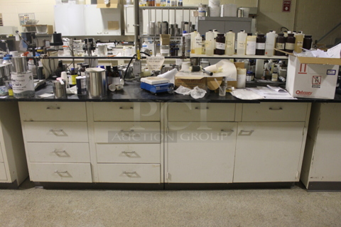 White Counter w/ Black Countertop, Doors, Drawers and Contents. BUYER MUST REMOVE.