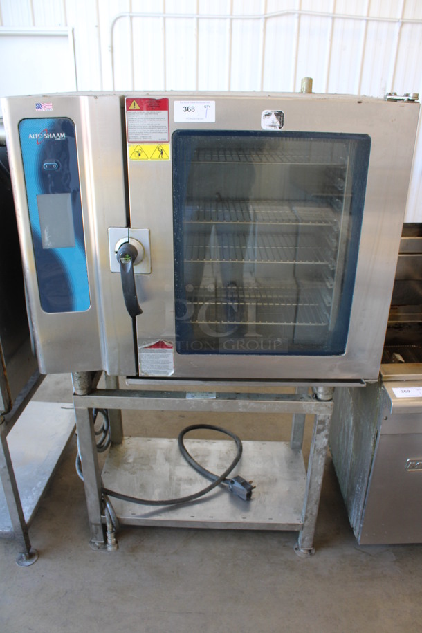 	2013 Alto Shaam Model 10.10 ESI Stainless Steel Commercial Electric Powered Combitherm Convection Oven w/ View Through Door and Metal Oven Racks on Stainless Steel Equipment Stand. 208-240 Volts, 3 Phase. 46x34x67