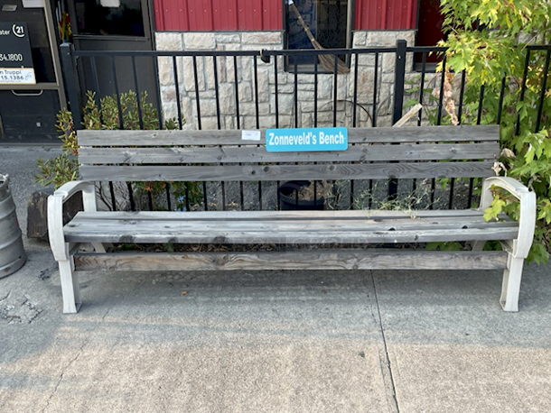 AMAZING!! Large Wooden Bench With Plastic Legs & Cup Holder In Each Arm Rest. "Zonneveld's Bench" Placard Removed - Image 1 of 2