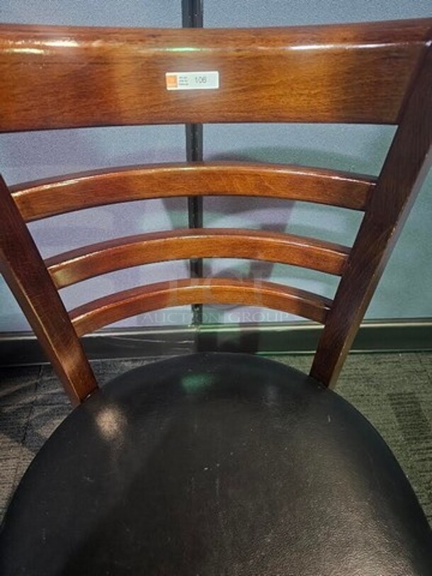 Wooden restaurant chair with black leather seat. 18.5" W x 33.5" L x 15" D. In good used condition, no broken pieces but have some marks and scuffs from normal wear. BIDX6 - Image 4 of 4