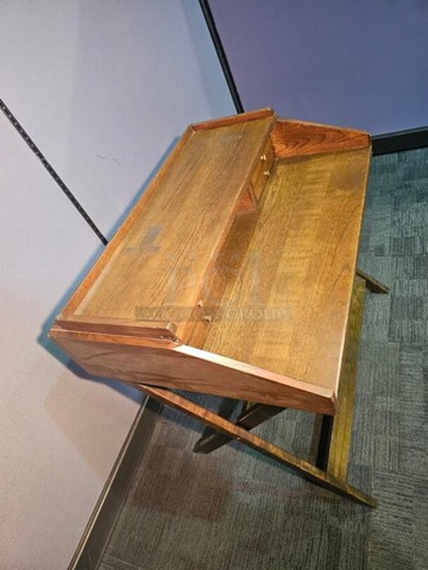 Antique wooden secretary style desk. Is two separate pieces. Bottom half folds out with a metal chain and the top part sits on. Nothing broken, in good condition. Could be cleaned up nicely to make a beautiful antique addition to any space! 36"H x 38"W x 27"D. 
 - Image 2 of 3