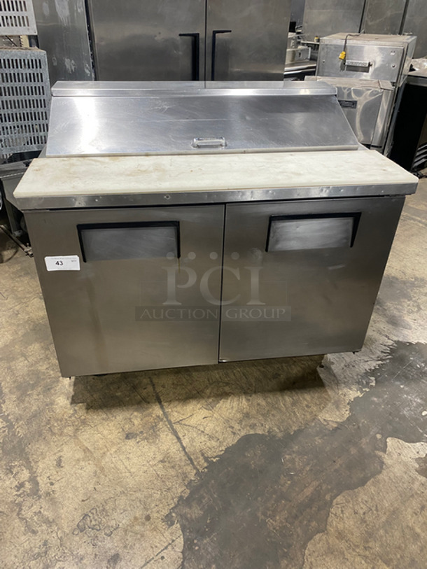 True Commercial Refrigerated Sandwich Prep Table! With Commercial Cutting Board! With 2 Door Underneath Storage Space! Poly Coated Racks! All Stainless Steel! On Casters! Model: TSSU4812 SN: 13941123 115V 60HZ 1 Phase