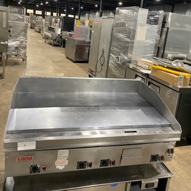 Lang Commercial Countertop 48 Inch Natural Gas Powered Polish Top Flat Top Griddle! With Back And Side Splashes! All Stainless Steel! On Small Legs! - Image 1 of 9