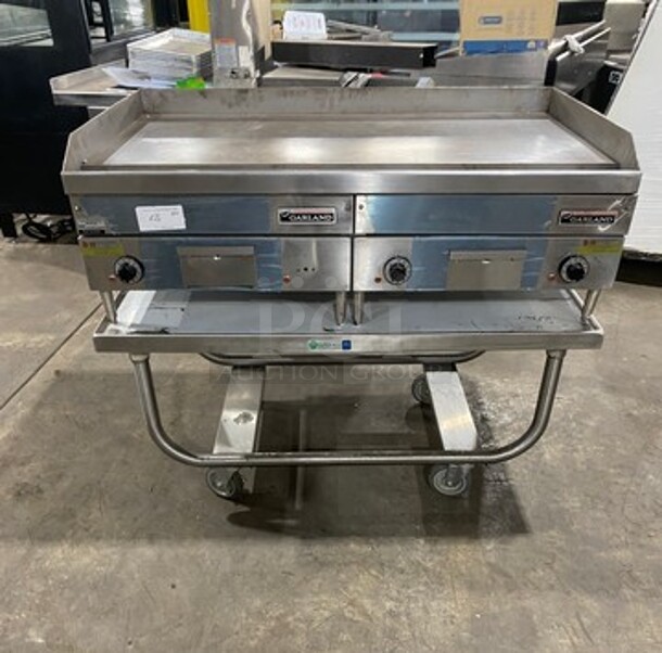 WOW! NEW! NEVER USED! Garland Commercial Countertop Electric Powered Flat Top Griddle! With Back And Side Splashes! On Legs! On Equipment Stand! All Stainless Steel! On Casters! Model: E2448G SN: 0404ME0033 208V 60HZ 3 Phase