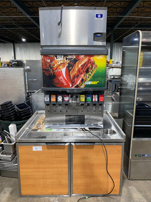 NICE FIND! Commercial Drink Station! Cornelius 8 Spout And Ice Dispenser Beverage System! With Manitowoc Ice Making Machine Head! On Equipment Stand! With 2 Door Underneath Storage Space! All Stainless Steel! 2x Your Bid Makes One Unit! Model: ED250BCZ SN: 62B1526ED015 115V 60HZ 1 Phase, Model: ID0302A161 SN: 1120067801 115V 60HZ 1 Phase