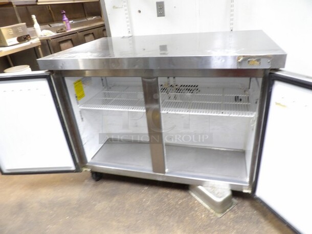 Maxx Cold, 2-Door Freezer Stainless Prep Table W/Moderate Wear. TESTED AND WORKING. 

Small Sections of Plastic on Inside of Doors Cracked/Missing and Dents/Scuffs to Inner Compartment. Missing One Castor and One Other Needs Reattached or Repaired. 

48.5"x30.25"x37.5" - Image 4 of 6