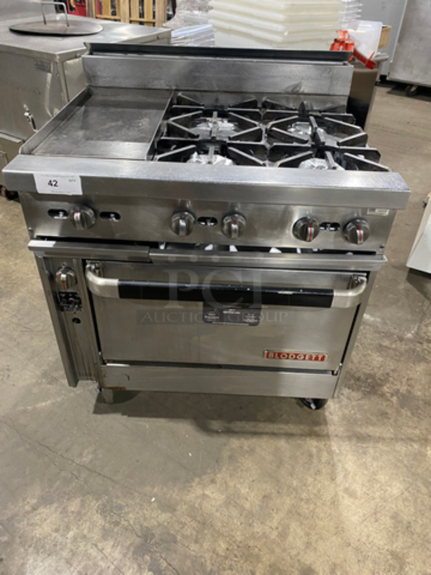 Blodgett Commercial Natural Gas Powered 4 Burner Range With Left Side Flat Griddle! Griddle Has Side Splashes! With Back Splash! With Oven Underneath! All Stainless Steel! On Casters!