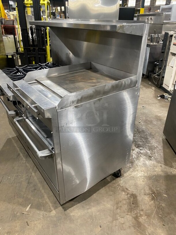 BEAUTIFUL! Garland Commercial Natural Gas Powered 6 Burner Stove With Raised Right Side Flat Griddle & Cheese Melter! Griddle Has Side Splashes! With Raised Back Splash And Salamander Shelf! With 2 Full Size Ovens Underneath! With Metal Oven Racks! All Stainless Steel! On Casters! - Image 2 of 9