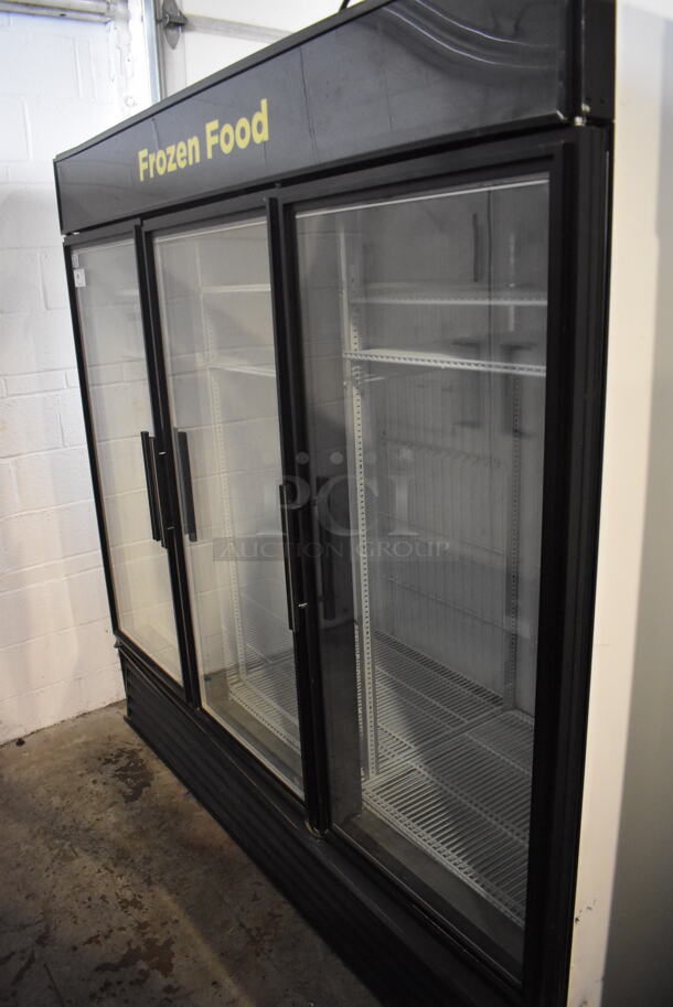 2014 True GDM-72F-LD Commercial Free Standing Electric Powered Triple Swing Glass Door Merchandiser Freezer In Black With Polycoated Racks. 115V/1 Phase Could Not Test Due To Different Plug Style