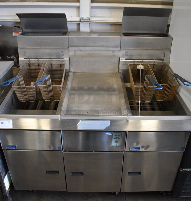 Pitco Frialator Model F14S-V Stainless Steel Commercial Floor Style Propane Gas 2 Bay Fryer w/ Center Dumping Station on Commercial Casters. 110,000 BTU. 49x32x54
