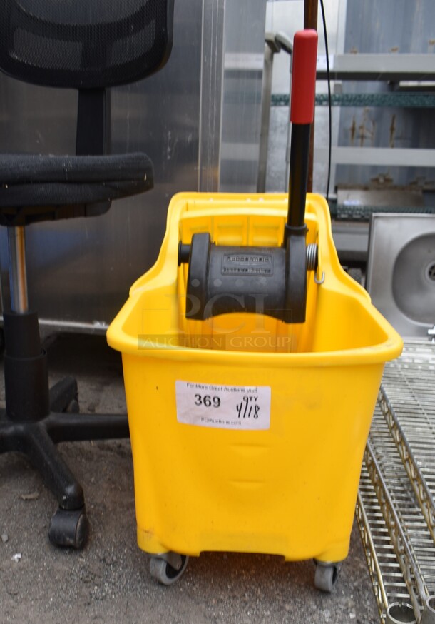 Yellow Poly Mop Bucket w/ Wringing Attachment on Casters.