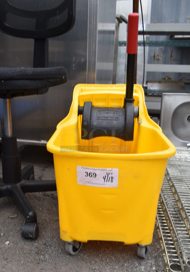 Yellow Poly Mop Bucket w/ Wringing Attachment on Casters. - Image 1 of 1