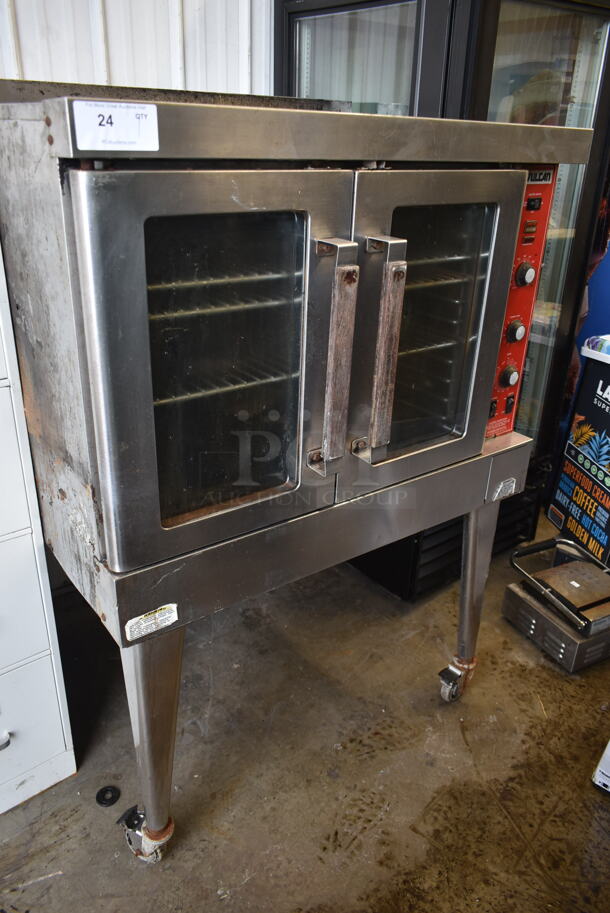 Vulcan VC4ED Stainless Steel Commercial Propane Gas Powered Full Size Convection Oven w/ View Through Doors, Metal Oven Racks and Thermostatic Controls on Metal Legs. 