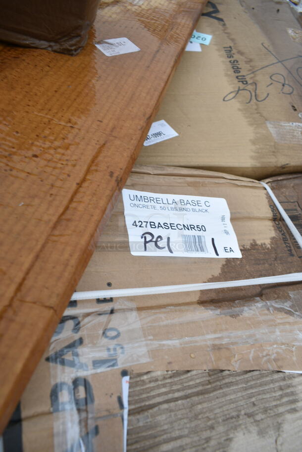 BRAND NEW SCRATCH AND DENT! 427BASECNR50 Lancaster Table & Seating 50 lb. Black Round Concrete Umbrella Base. May Be Missing Pieces.  - Image 3 of 3