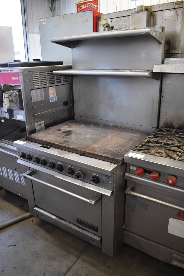 Garland Stainless Steel Commercial Electric Powered Flat Top Griddle, Oven and 2 Over Shelves on Commercial Casters. 208-220 Volts, 3 Phase. 36x38x69