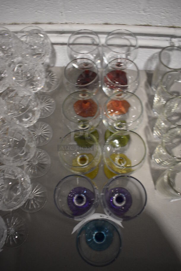 11 Wine Glasses w/ Various Colored Bases; 2 Red, 2 Orange, 2 Green, 2 Yellow, 2 Purple and 1 Blue. 3.5x3.5x7. 11 Times Your Bid! - Image 3 of 3