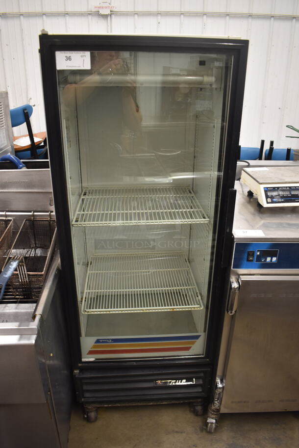 True GDM-12 Commercial Single Door White Reach-In Merchandiser Cooler With Polycoated Shelves On Commercial Casters. 115V, 1 Phase. Tested and Powers On But Does Not Get Cold