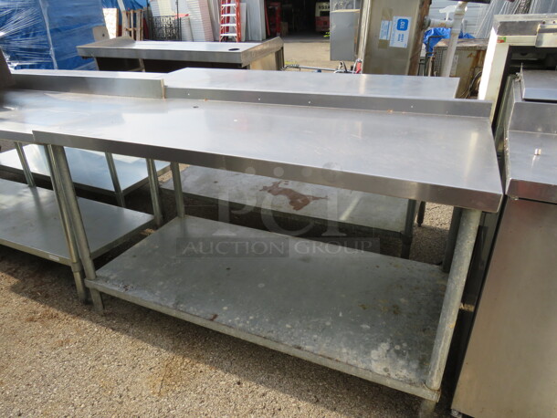 One Stainless Steel Table With Under Shelf And Back Splash. 60X30X37