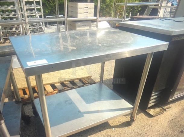 One Stainless Steel Table With SS Under Shelf On Casters. 42X30X36
