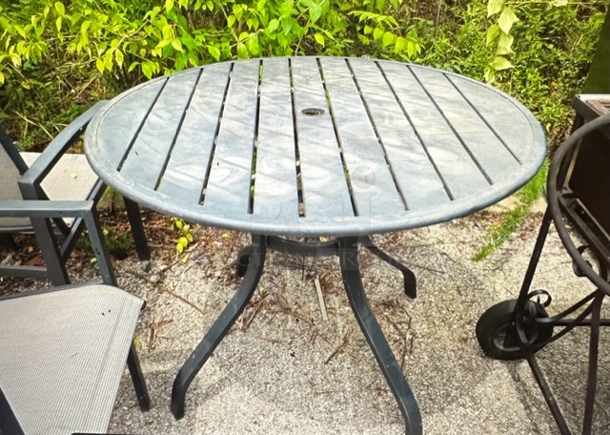 One Round Metal Patio Table.  - Image 1 of 1