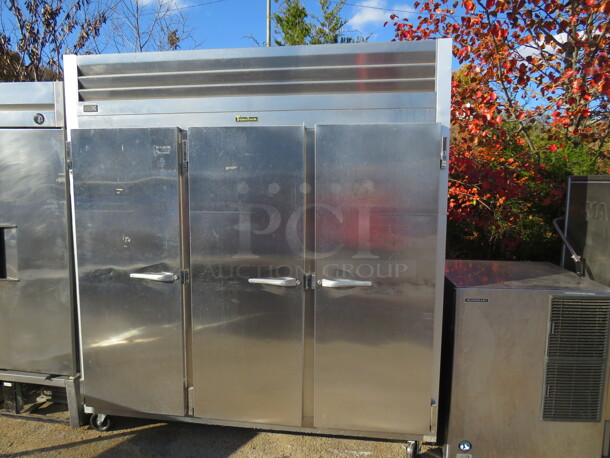 One Stainless Steel 3 Door Traulsen Refrigerator With 9 Shelves On Casters. 120 Volt. Model# G30011. 77X36X83.5