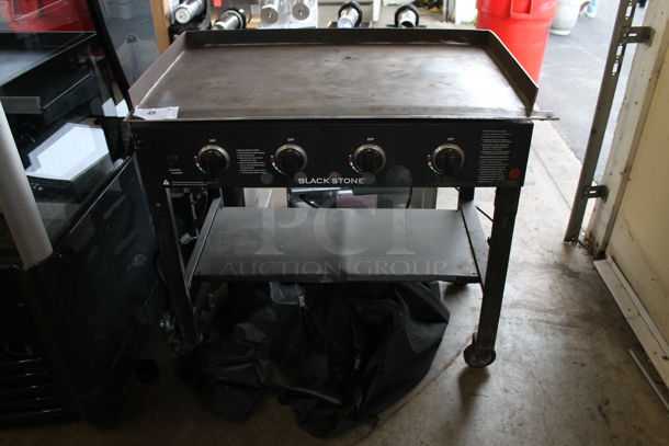 Black Stone 1554 Metal Portable Propane Gas Powered Catering Flat Top Griddle on Commercial Casters w/ Cover. 