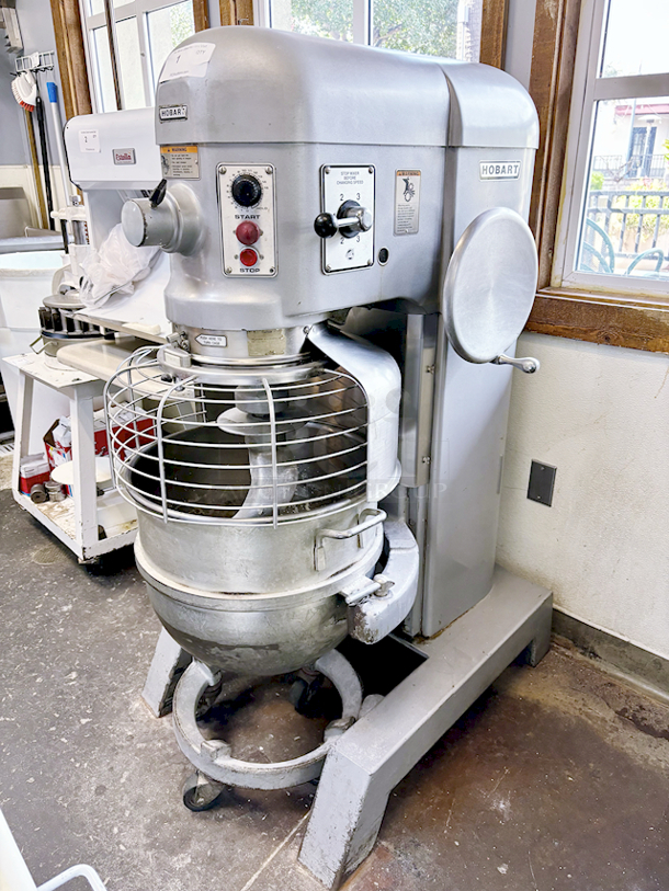 Hobart H600T 60 Qt. 4 Speed Planetary Floor Mixer. Tested. In Proper Working Order! Equipped With: Gear-Driven Transmission, 15-Min Timer, #12 Attachment Hub, Bowl Lift, Bowl Guard, Dough Whip,Bowl Caddie & 200V, 2HP, 5.8 Amp, 3PH. 
Serial Number: 31-1222-851