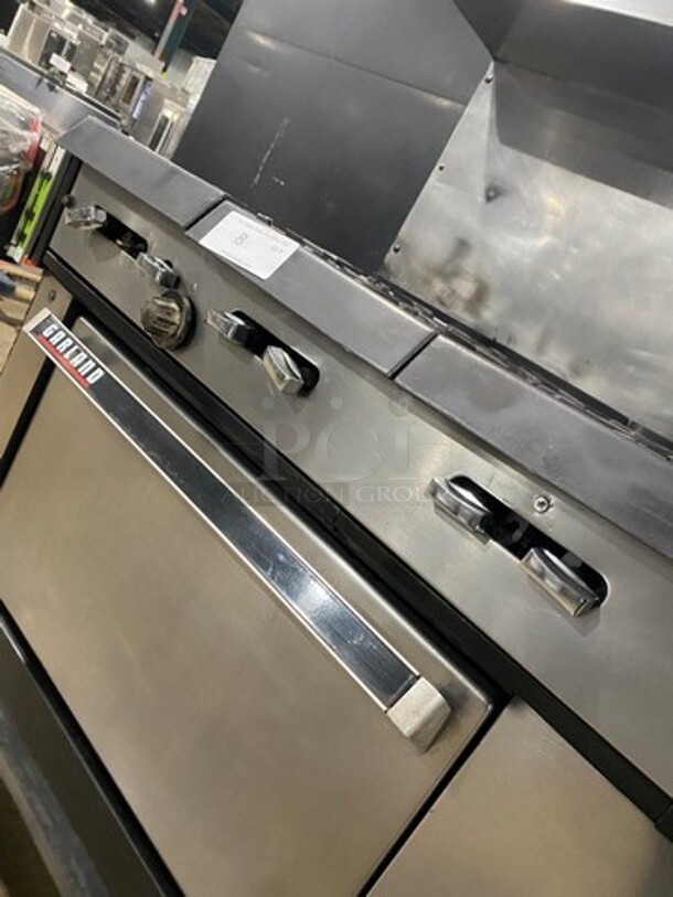 Garland Commercial Natural Gas Powered 12 Burner Stove! With 2 Full-Sized Ovens! With Metal Oven Racks! With Raised Back Splash & Salamander Shelf! Stainless Steel! On Casters! Working When Removed! - Image 9 of 10