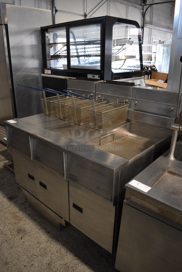 Pitco Frialator SG14-JS Stainless Steel Commercial Natural Gas Powered Floor Style 2 Bay Deep Fat Fryer w/ Right Side Pitco Frialator SGBNB14-0 Dumping Station, 4 Metal Fry Baskets and 2 Lids on Commercial Casters. 122,000 BTU. 47x35x46