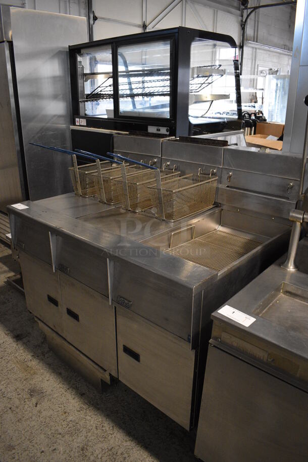 Pitco Frialator SG14-JS Stainless Steel Commercial Natural Gas Powered Floor Style 2 Bay Deep Fat Fryer w/ Right Side Pitco Frialator SGBNB14-0 Dumping Station, 4 Metal Fry Baskets and 2 Lids on Commercial Casters. 122,000 BTU. 47x35x46 - Image 1 of 12
