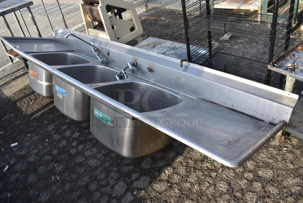 Stainless Steel Commercial 3 Bay Sink w/ Dual Drain Boards, 2 Faucets and Handle Sets. No Legs. 120x29x24. Bays 22x22x14. Drain Boards 22x25x1