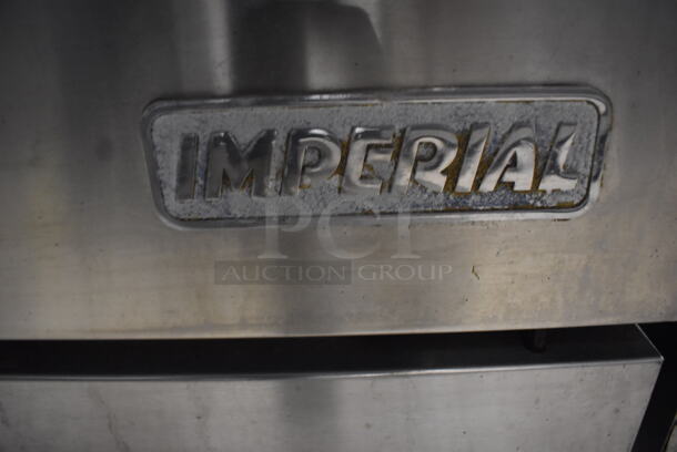 Imperial Commercial Stainless Steel Natural Gas Range With 10  Burners and 2 Ovens With Metal Racks On Commercial Casters.  - Image 7 of 7