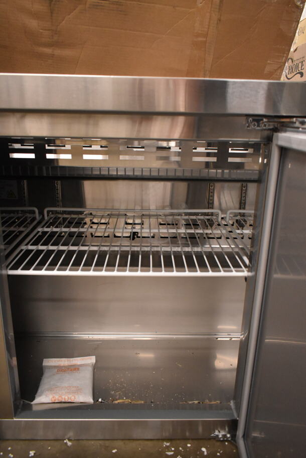 BRAND NEW SCRATCH AND DENT! 2023 Avantco 178SSPT71HC Stainless Steel Commercial Refrigerated Sandwich Prep Table. Missing Door and Top. 115 Volts, 1 Phase. Tested and Powers On But Does Not Get Cold - Image 5 of 7