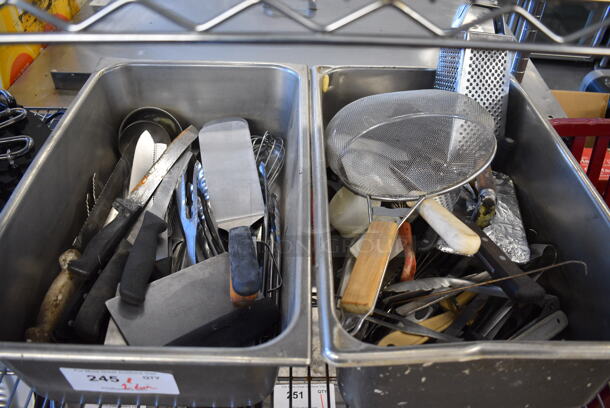 ALL ONE MONEY! Lot of 2 Bins of Various Utensils Including Strainer, Spatula, Tongs and Knives in 2 Stainless Steel Drop In Bins