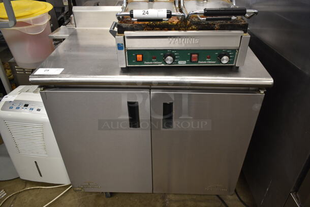 Advance Tabco Stainless Steel Commercial Counter w/ Back Splash and 2 Doors on Commercial Casters.