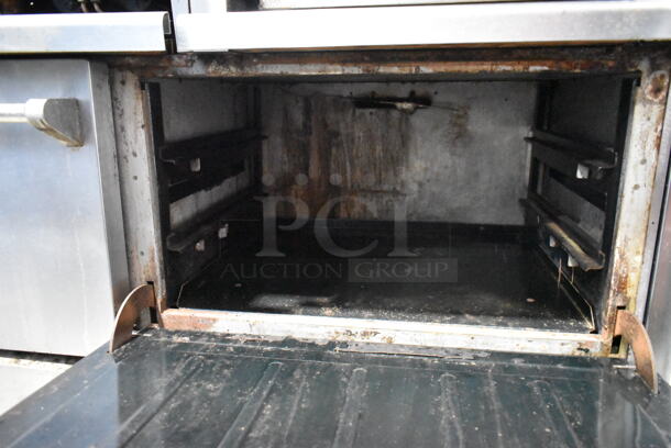 Vulcan VG260 Stainless Steel Commercial Natural Gas Powered 6 Burner Range w/ Right Side Flat Top Griddle, 2 Ovens, Over Shelf and Back Splash on Commercial Casters.   - Image 8 of 11