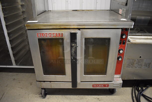 Blodgett Mark V Stainless Steel Commercial Electric Powered Full Size Convection Oven w/ View Through Doors, Metal Oven Racks and Thermostatic Controls on Commercial Casters. 208 Volts, 3 Phase. 39x37x35