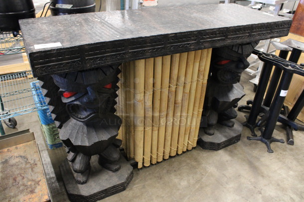 Tiki Style Bar w/ Black Textured Tabletop, 2 Totem Pole Style Table Bases and Bamboo Pattern Center Accent. 63x21.5x41.5