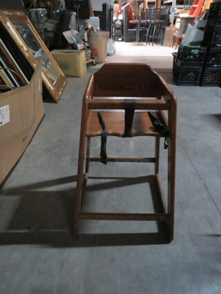 One Wooden High Chair With Safety Straps. 