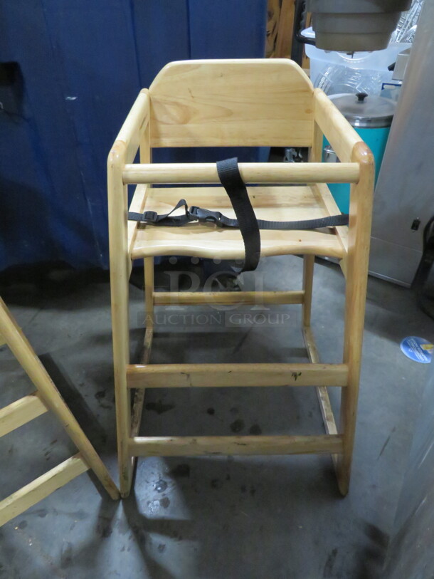 One Wooden High Chair With Safety Straps.