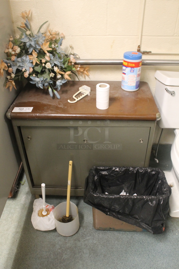 ALL ONE MONEY! Metal Cabinet w/ Wood Pattern Top, Contents, Fake Flowers, Plunger, Toilet Bowl Cleaner and Trash Can. - Image 1 of 3