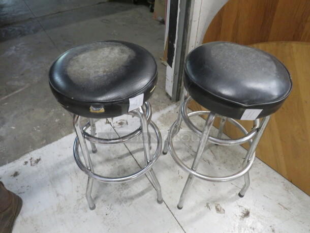 Double Chrome Ring Bar Stool With A Black Cushioned Swivel Seat. Need To Be Recovered. 2XBID - Image 1 of 1