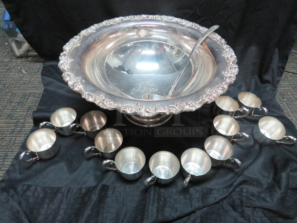 One Silver Punch Bowl With Matching Ladle, And 12 Cups.