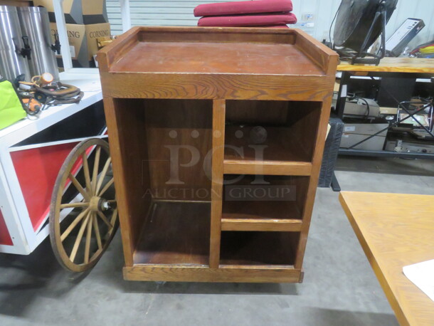 One Wooden Hostess Stand With Under Storage, On Casters, With A Please Wait To Be Seated Sign. 37X27X53