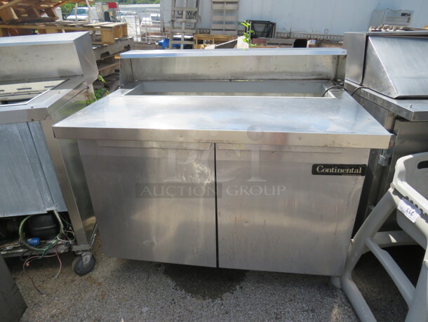 One 2 Door Continental 2 Door Refrigerated Prep Table On Casters. #SW48-12C. 115 Volt. Working Not Cold. 48X38X42