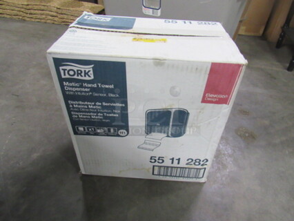 One NEW Tork Hand Towel Dispenser.