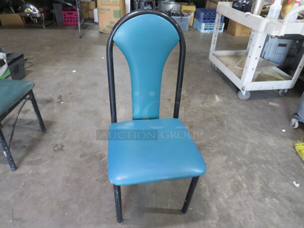 One Black Metal Chair With A Teal Cushioned Seat, And Back. 