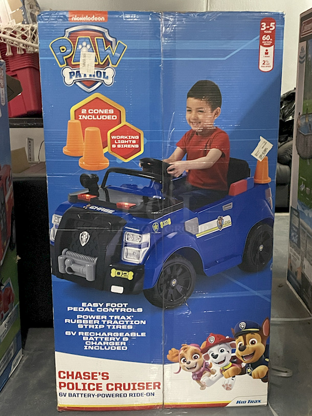 NEW IN ORIGINAL PACKAGING!! Kid Trax Nickelodeon Paw Patrol Chase's Police Cruiser 6v Battery-Powered Ride-On. Includes: 6v Battery & Charger, 2 Cones & Working Lights & Siren.  - Image 1 of 3