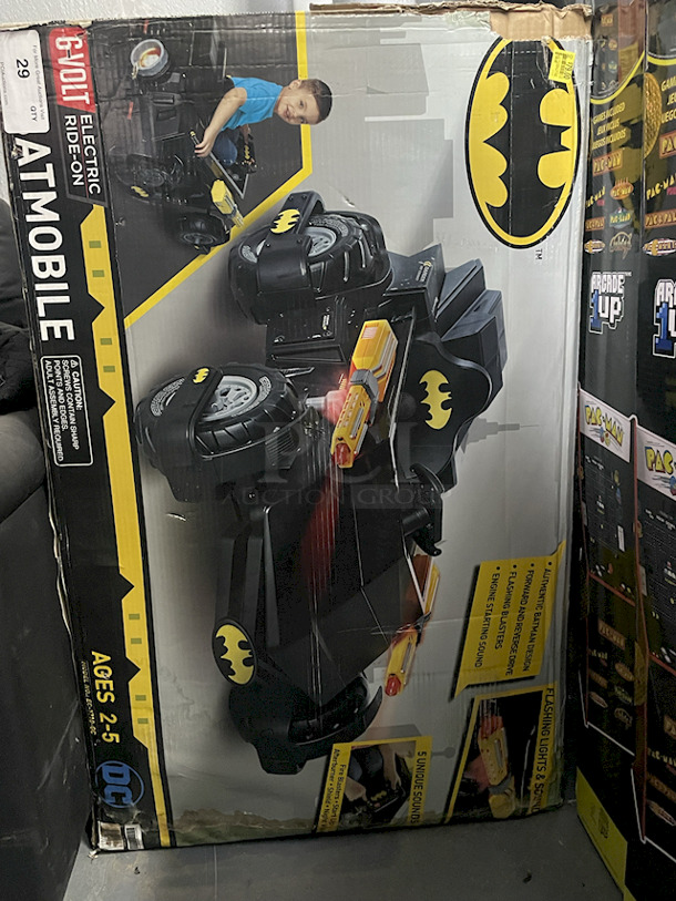 NEW/NEVER USED - DC Batmobile Car, Model: EC-1710-GC – Authentic Batman Design6v Electric Ride-On ; Forward & Reverse Drive; Flashing Blasters; Engine Starting Sound; (5) Unique Sounds: Fire Blasters – Start Up – Afterburner – Shield – Night Vision. Top of box is open, all parts appear to be in the box in original packaging. 