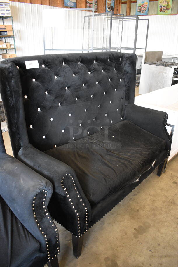 Black Chair w/ Arm Rests and Nail Head Trim. One Leg Needs To Be Secured. 59x30x50